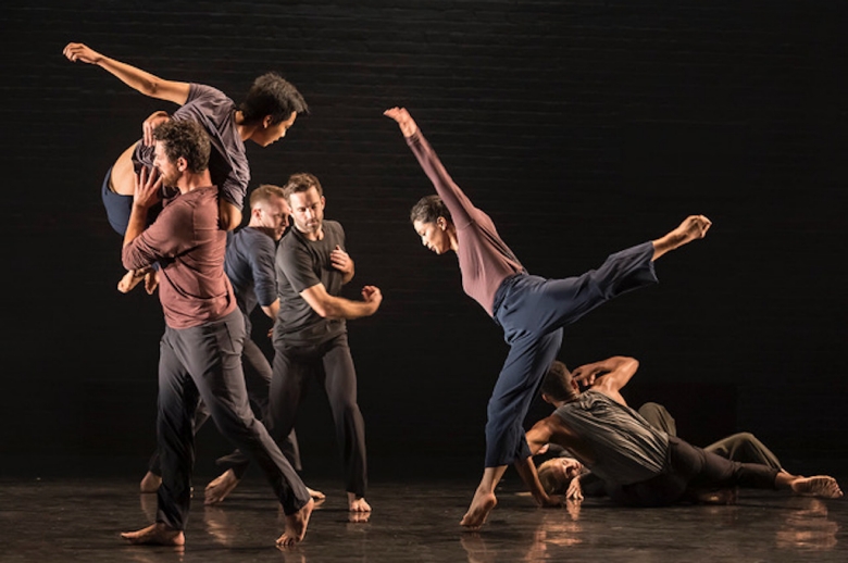 Image of a group of dancers on stage in mid performance